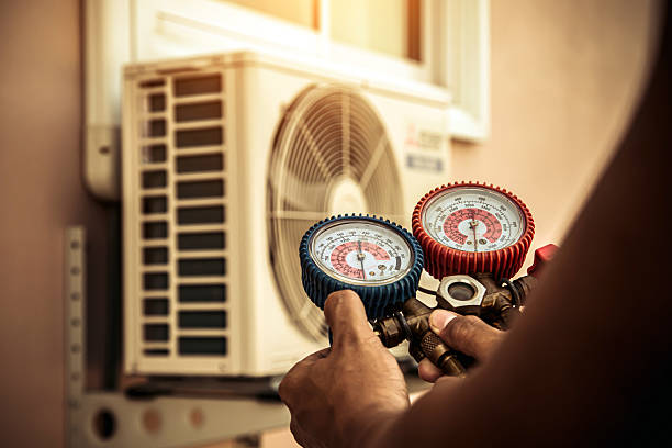 Professional Heat Pump Repair technician working in Wellington, MO